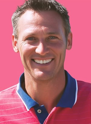 Portrait of a man in pink shirt smiling