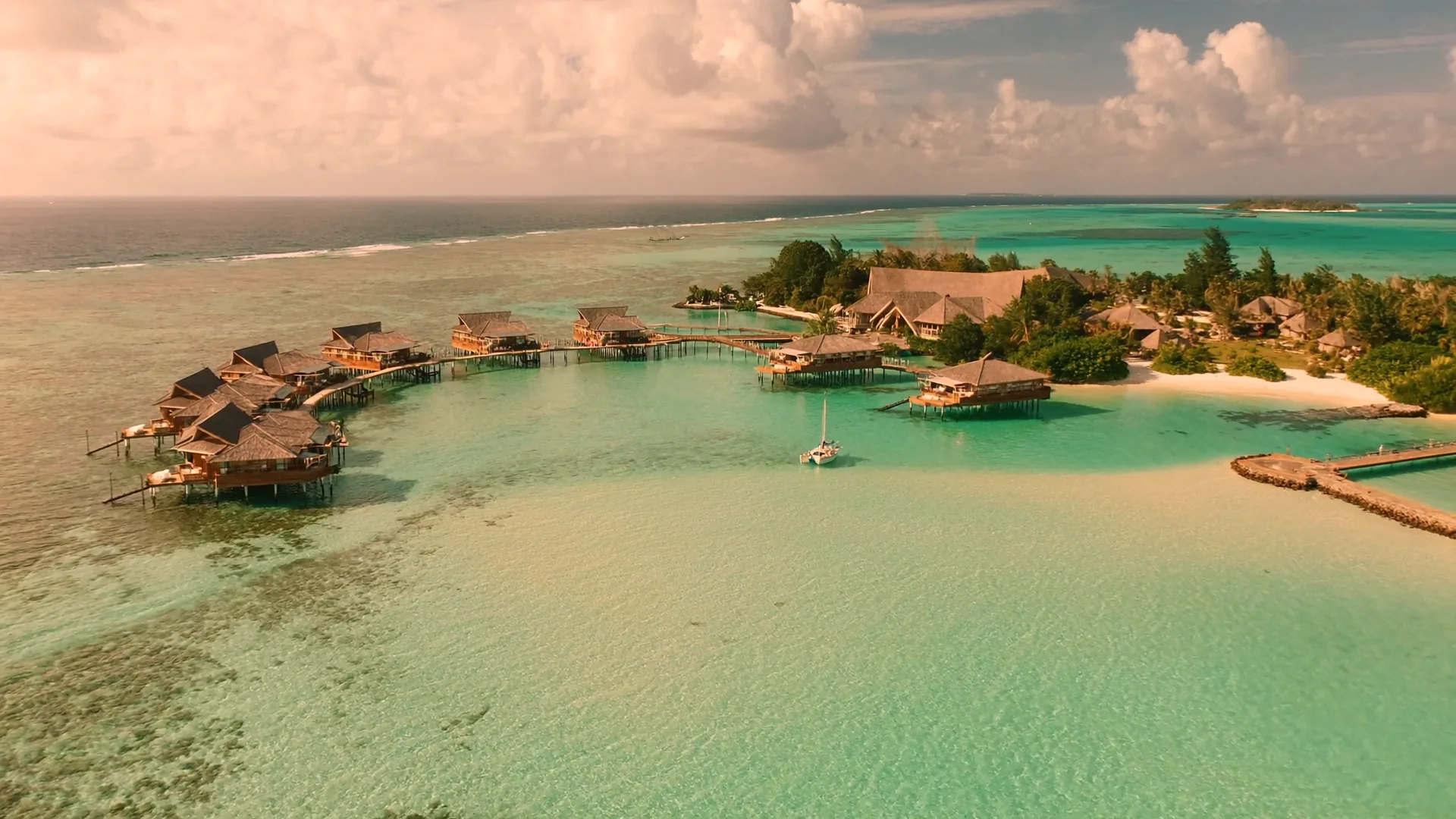 Aerial view of an Indian Ocean lagoon at golden hour representing the AI visibility challenges faced by island hospitality properties