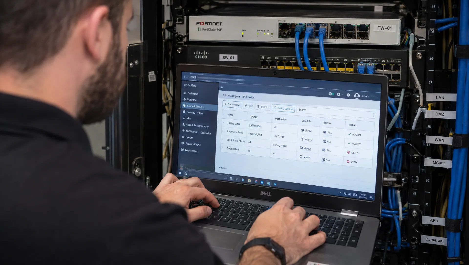 An MSP engineer checks a firewall configuration at a client network cabinet during technical evaluation.